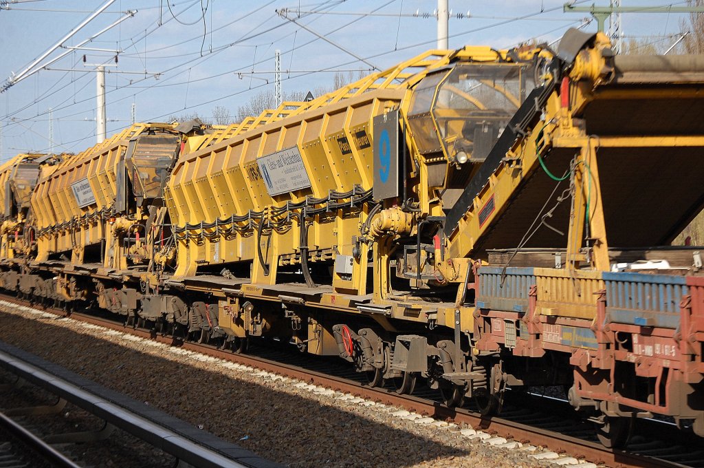 Die h�ufig l�ngsten und markantesten Bahnbauz�ge bestehen aus einer Vielzahl gleichartiger Bahnbaumschinen den Materialf�rder- und Siloeinheiten vom Hersteller Plasser & Theurer  vom Typ MFS 100, im Bild die Maschine Nr.9 der Fa. MGW GmbH aus Berlin, 16.04.10 Berlin-Blankenburg.  