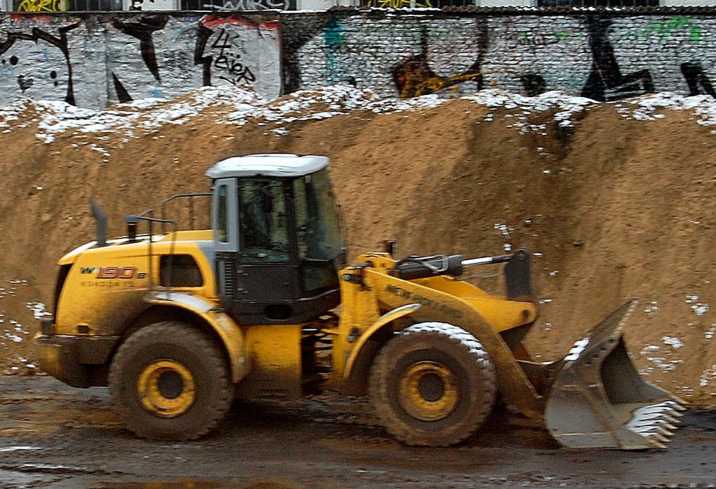 NEW HOLLAND W190B Radlader, Bild durchs S-Bahnfenster entstanden, 27.11.10 Berlin-Ostkreuz.  