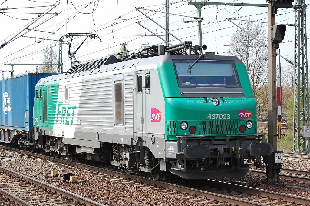 SNCF Leasinglok Prima EL3U 437023 (Alstom Bj.2004) f�r ITL unterwegs mit dem Containerzug  Blaue Wand  bei der Durchfahrt im Bhf. Flughafen Berlin-Sch�nefeld, 24.04.10