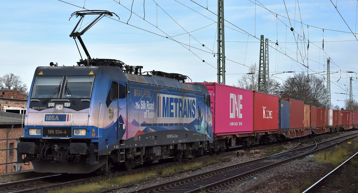 METRANS Rail s.r.o., Praha-Uhříněves [CZ] mit der geleasten Railpool Lok  186 534-4  [NVR-Nummer: 91 80 6186 534-4 D-Rpool] und einem Containerzug am 08.12.25 Höhe Bahnhof Magdeburg-Neustadt.